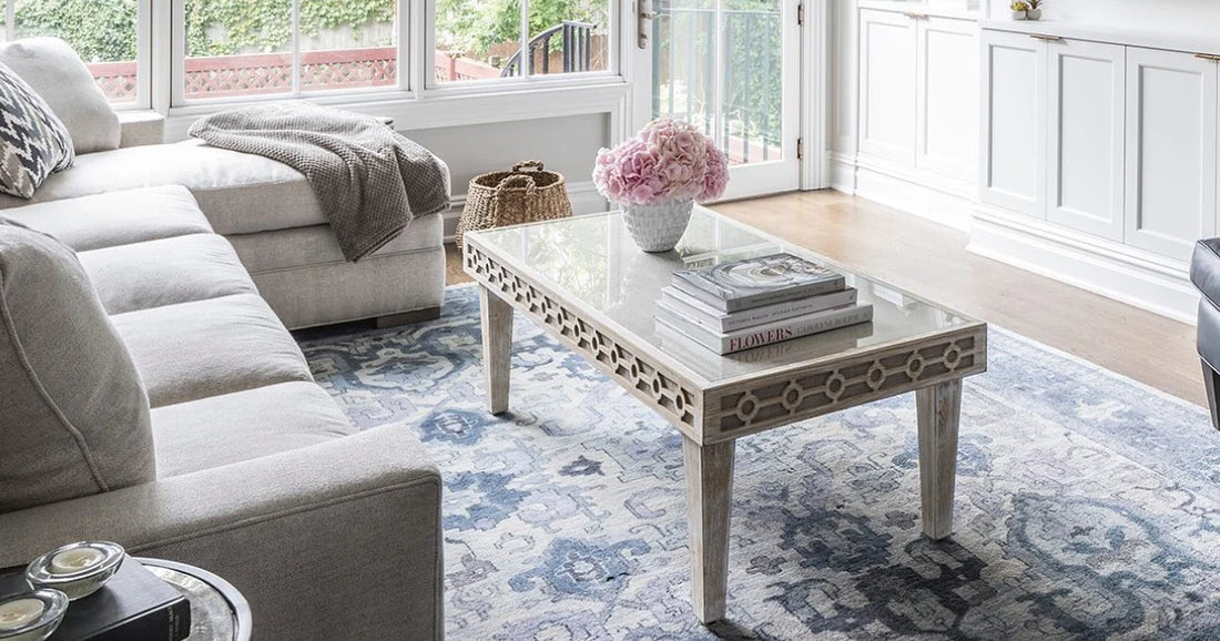 A bright and airy modern living room with modern home decor and a traditional area rug middle of the room. 