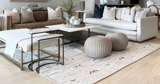 Elegant neutral living room with cozy decor, modern furniture, and an ivory area rug centerpiece.