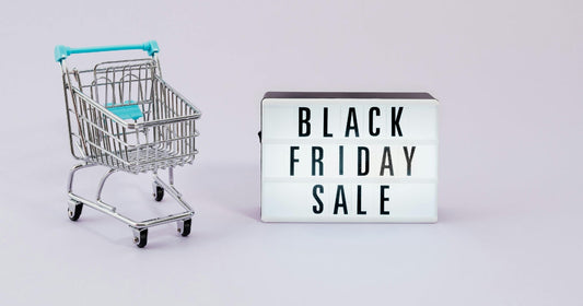 ini shopping cart with a 'Black Friday Sale' sign on a light background.