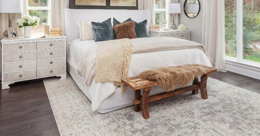 Cozy bedroom with layered textures and the Amelia Traditional Charcoal Light Gray Beige Rug.