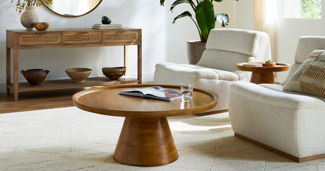 A living room with a coffee table, lounge chairs and the Ashmore Cottage Off-White Area Rug.