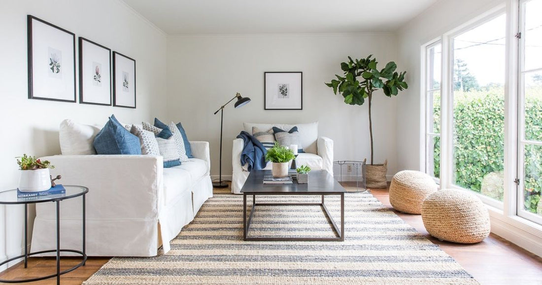 A living room furnished with a large jute rug and seating group