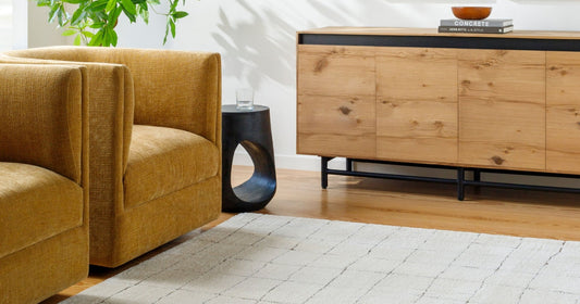 Modern living room with mustard chairs, wooden sideboard, and the Cascade Modern Ivory Area Rug.