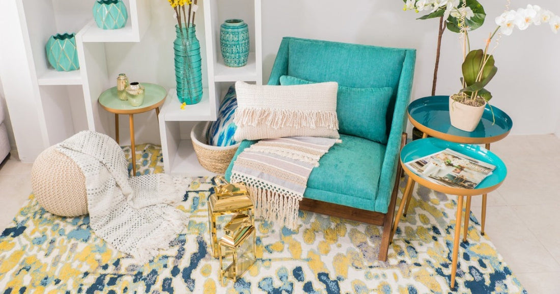 Vibrant room with turquoise chair, colorful decor, and patterned rug with yellow and blue accents.