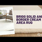 Brigg Solid and Border Cream Area Rug